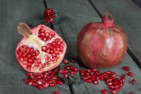 Still life of pomegranates on wooden tableの写真素材