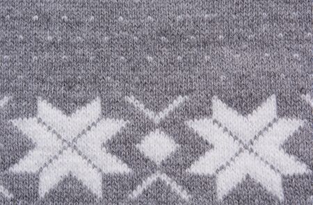 Knitted pattern with white snowflakesの写真素材