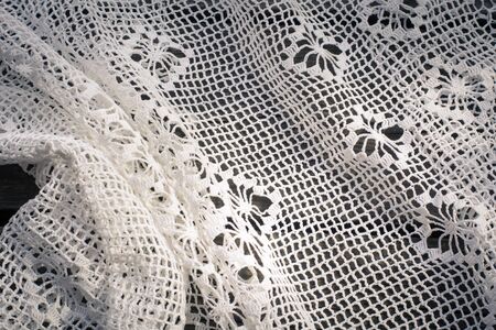 Crochet  white lace on wooden boardの写真素材