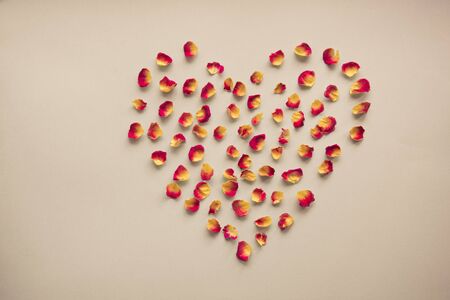 Valentines card. Heart symbol made of dried roses on a vintage background. Top view, flat lay. Concept, postcard with place for your text. Vintage filter.の写真素材