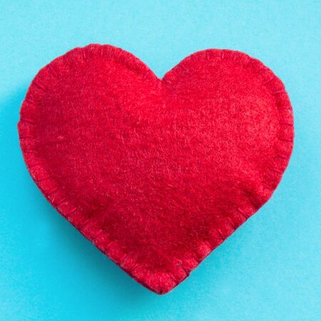 Valentines day card. Red felt heart on blue background. Top view.の写真素材