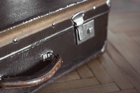 Vintage closed suitcase on the old parquet.の写真素材
