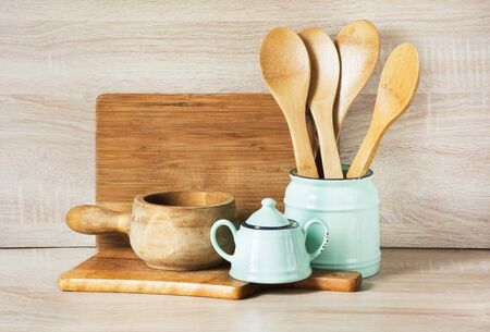 Turquoise and wooden vintage crockery, tableware, dishware utensils and stuff on wooden table-top. Kitchen still life as background for design. Image with copy space.の写真素材