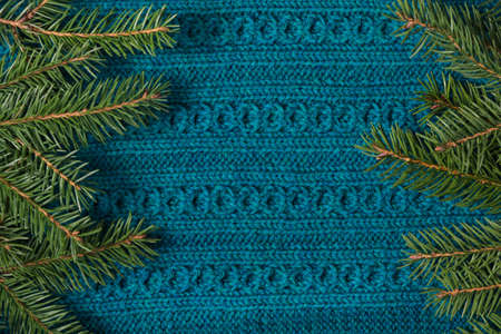 Fir tree as frame on knitted sweater background. Christmas concept. Abstract pattern.