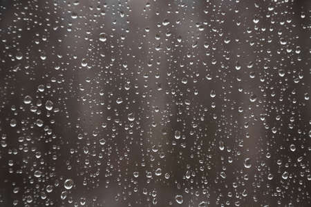 Rain drops on the window on the dark background. Natural pattern.Fall.