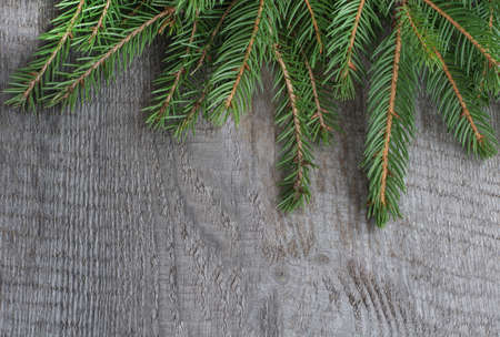 Christmas fir tree with cones on a wooden background, christmas background. Top view with copy space