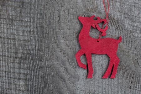 Christmas red deer decoration on wooden board. Top view.の写真素材