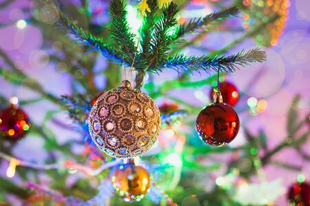 Christmas silver balls on christmas tree. Indoors. Close up.