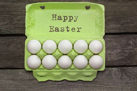Green carton of organic eggs on wooden background. Top view.の写真素材