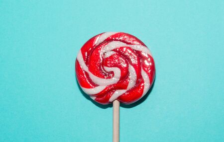 Lollipops red candy on blue background. Funny concept. Top view.の写真素材