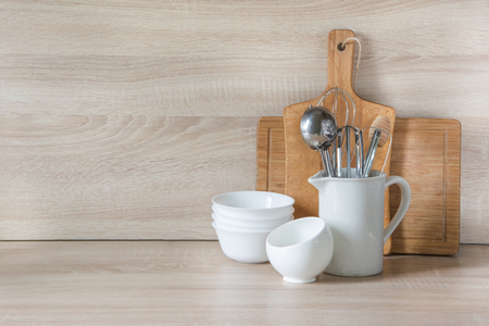 Crockery, tableware, utensils and other different stuff on wooden table-top. Kitchen still life as background for design.  Image with copy space.の写真素材