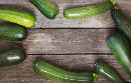 Fresh organic zucchini on the wooden table. Top view.の写真素材