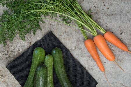 Fresh organic zucchini and carrot on the rustic table. Top view.の写真素材