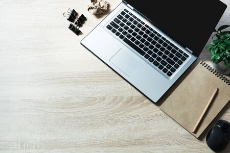 Open laptop and on office wooden desk table. Top view and copy space.