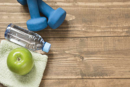 Sport and fitness equipment, creative flat lay on wooden board. Space for you.の写真素材