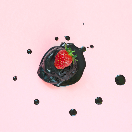 Creative still life of black ice cream in waffle cone on pastel pinkbackground. Spring concept. Top view.の写真素材