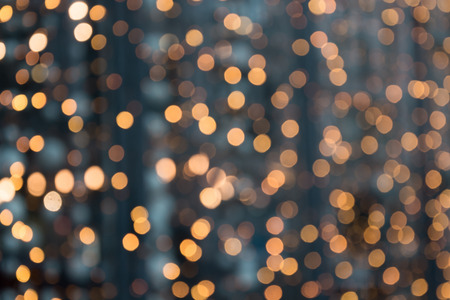 Christmas abstract background. Blurred golden garland blur bokeh, defocused pattern.