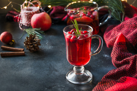Christmas cranberry cocktail garnish rosemary and fir branches on black . Close up. Xmas drink.の写真素材
