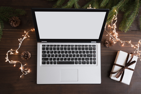 Screen laptop with space for text or special Christmas offer. Xmas shopping by laptop. Top view and flat lay. Holiday conceptの写真素材