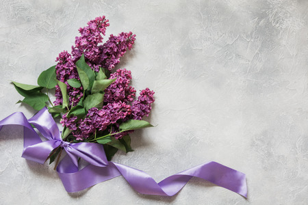 Bouquet of purple lilacs on light vintage table. Spring concept. View from above. Space for text.の写真素材