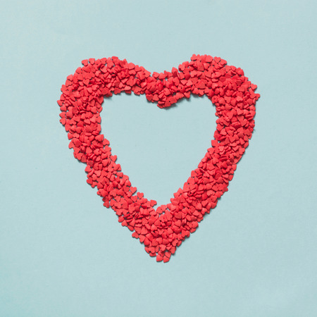 Valentine's card. Creative heart of red confetti. Top view. Flat lay.の写真素材
