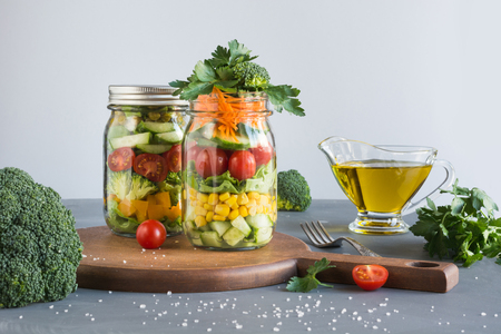 Clean eating. Vegetable healthy detox salad in mason jar with tomato, lettuce, broccoli. Copy space. Lunch for work.の写真素材