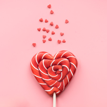 Valentine's card. Lollipops candy as heart on pink background. Funny concept.の写真素材