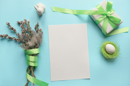 Easter party planner. Pussy-willow bunch and gift on blue. Space for text.