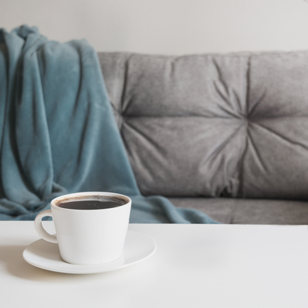 Cup of black coffee in interior for take a break and meditation with soft cozy couch.の写真素材