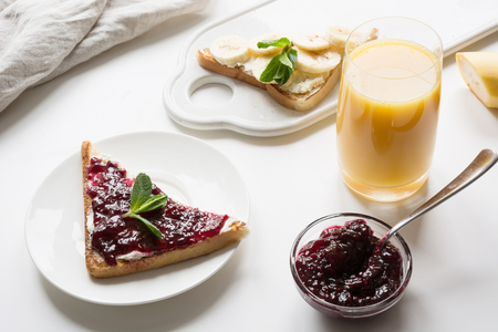Sandwiches for healthy breakfast with berry jam, bananas.の写真素材