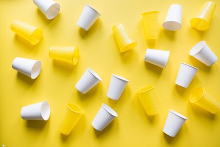 Disposable picnic utensils for recycling on yellow. Environment eco friendly discarded plastic garbage collection for recycle concept.Top view. Flat lay. Pattern.の写真素材