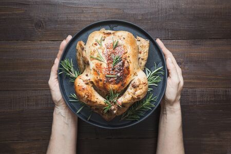Traditional roasted turkey garnish vegetables and rosemary on dark wooden table. Top view. Horizontal orientation. Thanksgiving day.の写真素材