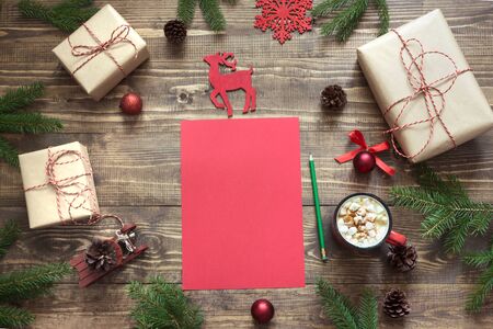 Christmas composition with giftbox. Empty red blank letter for Santa or your wishlist or advent activities. Top view and space for text.の写真素材