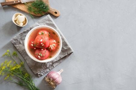 Marinated peeled tomatoes with garlic and dill, fresh ready to serve. Top view.の写真素材