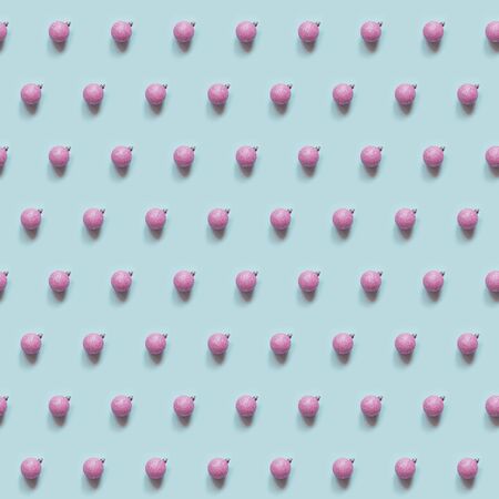 Seamless pattern of pink silver balls on blue. Xmas texture.