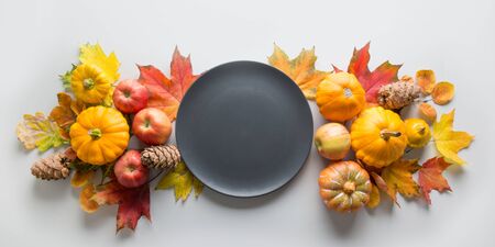 Fall decor for Thanksgiving Day with pumpkins, leaves, apples on grey table. View from above. Horizontal orientation. Space for text.の写真素材