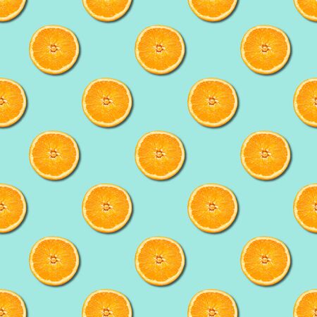 Seamless pattern of orange sliced on neo mint green color background. Minimal, flat lay, food...