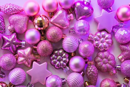 Christmas decoration balls different shapes in neon rays. Top view. Xmas pattern. Happy New Year.の写真素材
