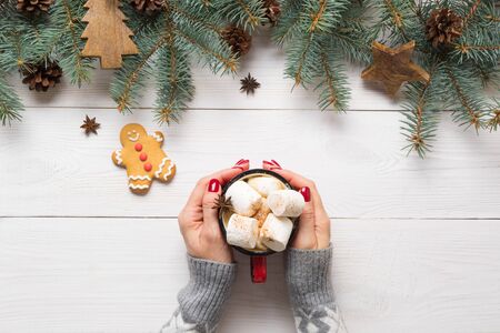 Christmas composition of fir branches, gingerbread cookies, wooden toys and cozy beverage coffee...