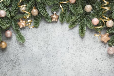 Christmas winter arch with fir branches, classic blue balls on natural grey background. Xmas greeting card. Holiday time. Happy New Year. Space for text. View from above, flat lay.の写真素材