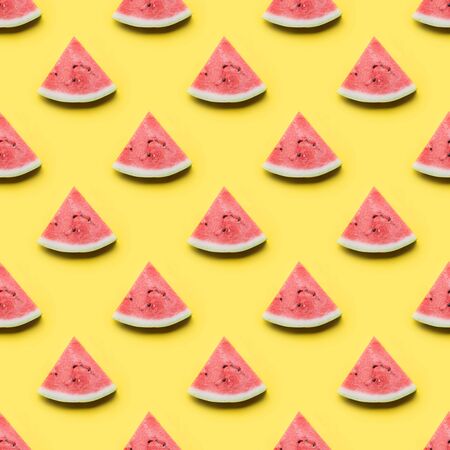 Seamless pattern of watermelon sliced on yellow background. Flat lay. Food concept.