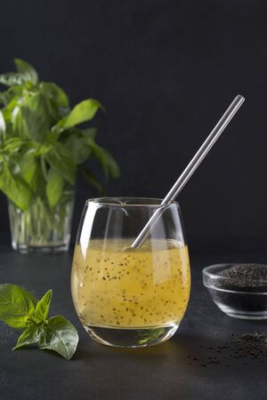 Basil seed drink with orange juice in glass on black background. Close up.の写真素材