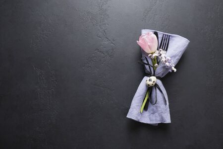 Elegance table setting spring pink tulip on black. Easter dinner. Top view.の写真素材