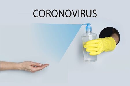 Woman holds out her hand for gel disinfection to protect against Coronavirus infection. COVID19. Text - Coronavirus.の写真素材