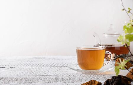 Chaga mushrooms infusion in glass cup. Trendy healthy beverage. Close up.の写真素材