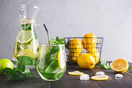 Detox water or lemonade with lemon mint, citrics in glass on grey background.の写真素材