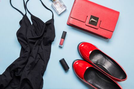 Little black dress and classic red accessories for party or special date. Flat lay, top view. Copy space.の写真素材