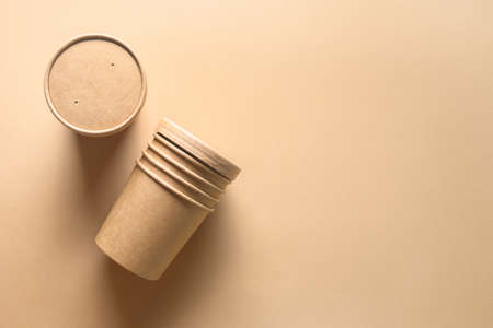 Craft paper soup cup on brown background. Empty container. Ecological individual package. Zero Waste. Top view.の写真素材
