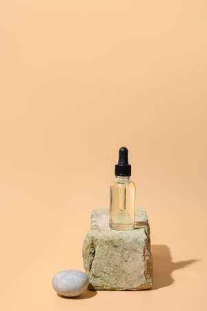 Cosmetic oil and natural materials in composition with shadow on beige background. Close up.の写真素材