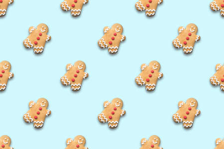 Seamless pattern of Christmas gingerbread man on blue background. Xmas abstract holiday background.